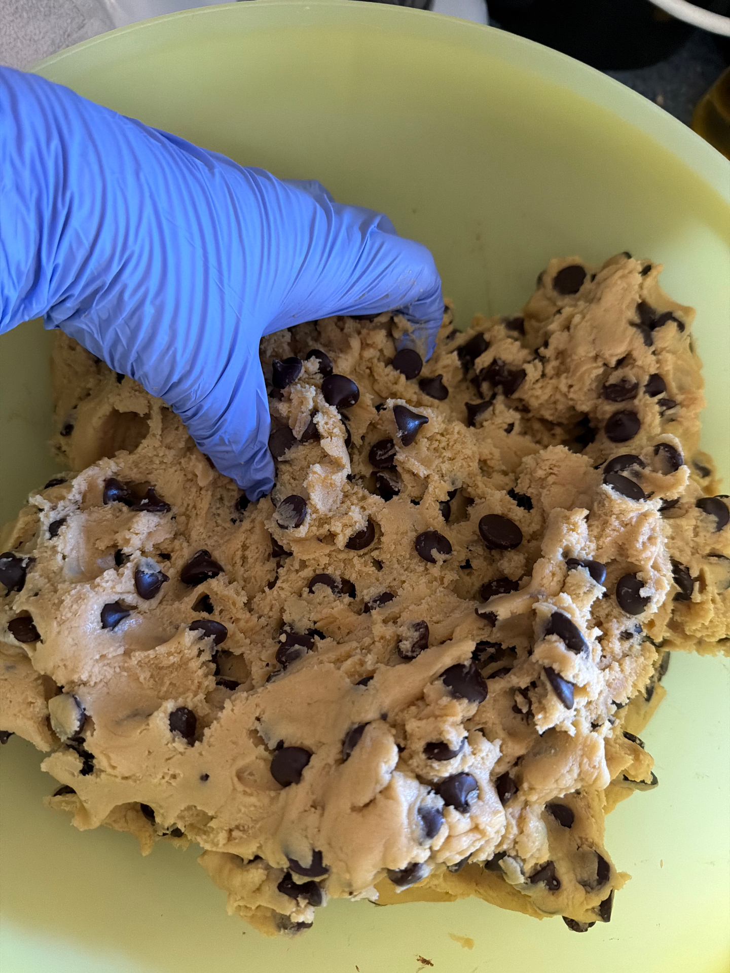 Hand-mixing sourdough chocolate chip cookie dough loaded with chocolate chips